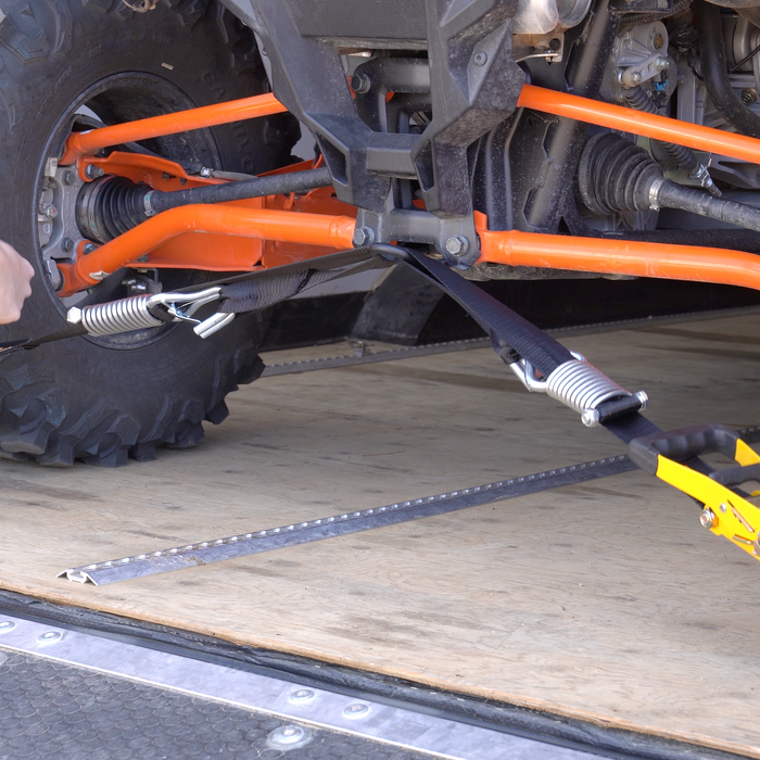 TorkStrap Pro holding down a large UTV on a trailer