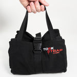 The main display image of a person holding the TorkBag which is a cargo strap organizing carrier.